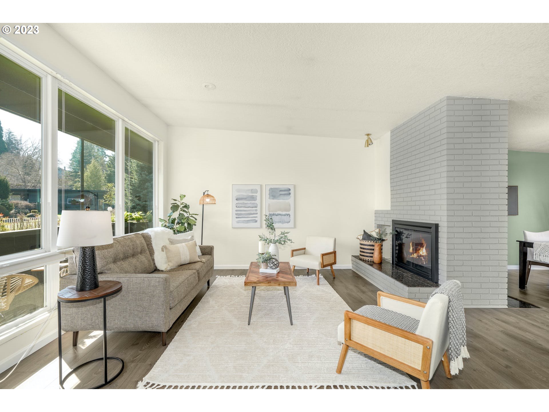5225 Southwest Oleson Road, Unit 10 Portland, OR 97225 - Photo 5 of 30 a living room with furniture a fireplace and a large window