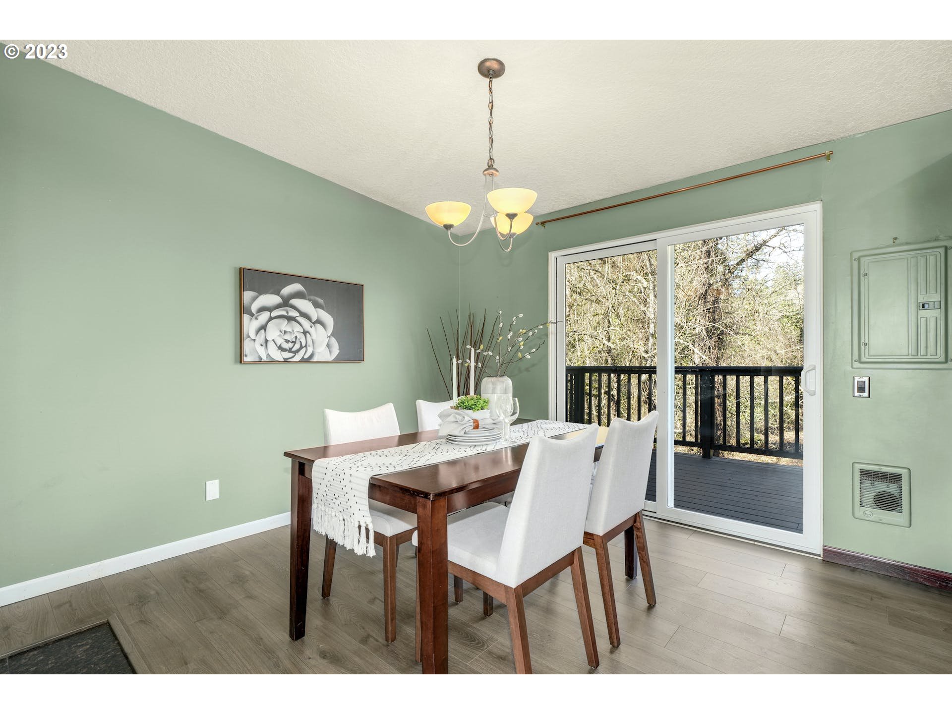 5225 Southwest Oleson Road, Unit 10 Portland, OR 97225 - Photo 9 of 30 a view of a dining room with furniture large window and wooden floor