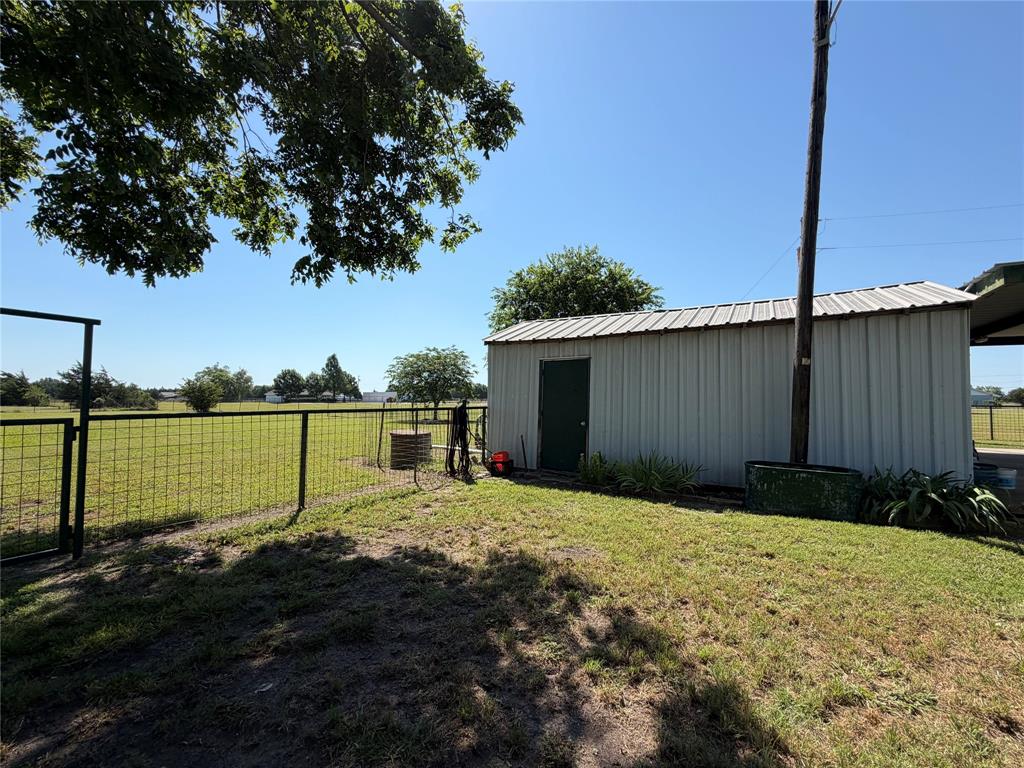330 South Goode Road Wilmer, TX 75172 - Photo 32 of 38 a backyard of a house with lots of green space and fountain