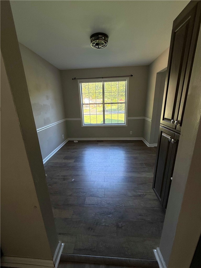 116 Kelly Lane Easley, SC 29642 - Photo 3 of 39 Rich wood-look flooring and elegant chair rail molding define this versatile dining area.