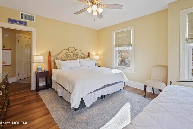 a bedroom with a large bed and flat tv