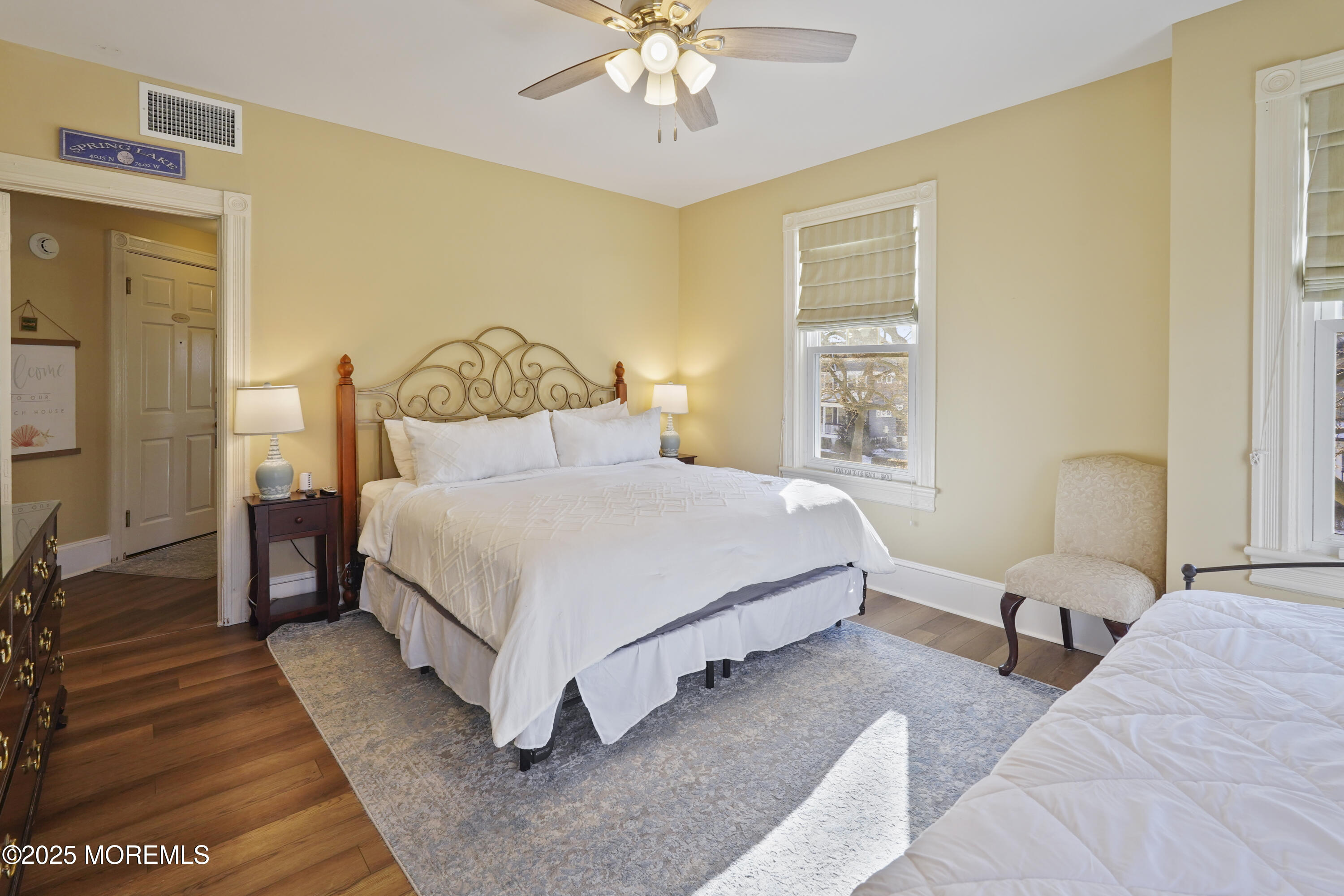 200 Monmouth Avenue, Unit 21 Spring Lake, NJ 07762 - Photo 19 of 37 a bedroom with a bed and a chandelier