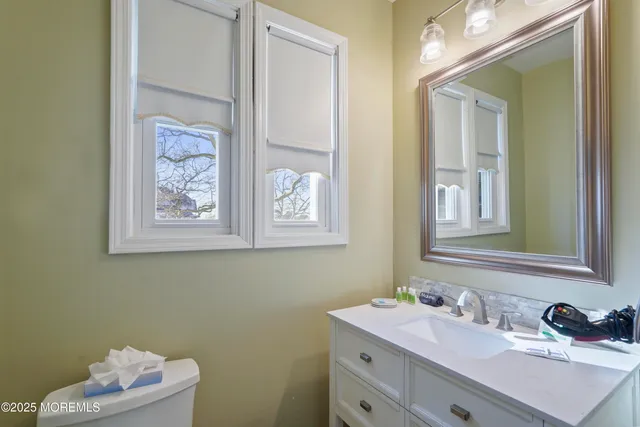 a front view of a building with lot of cars and trees