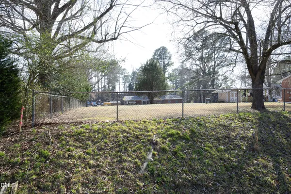 a view of a yard with large trees