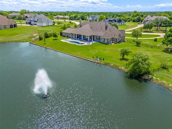 a aerial view of a house with a garden and lake view