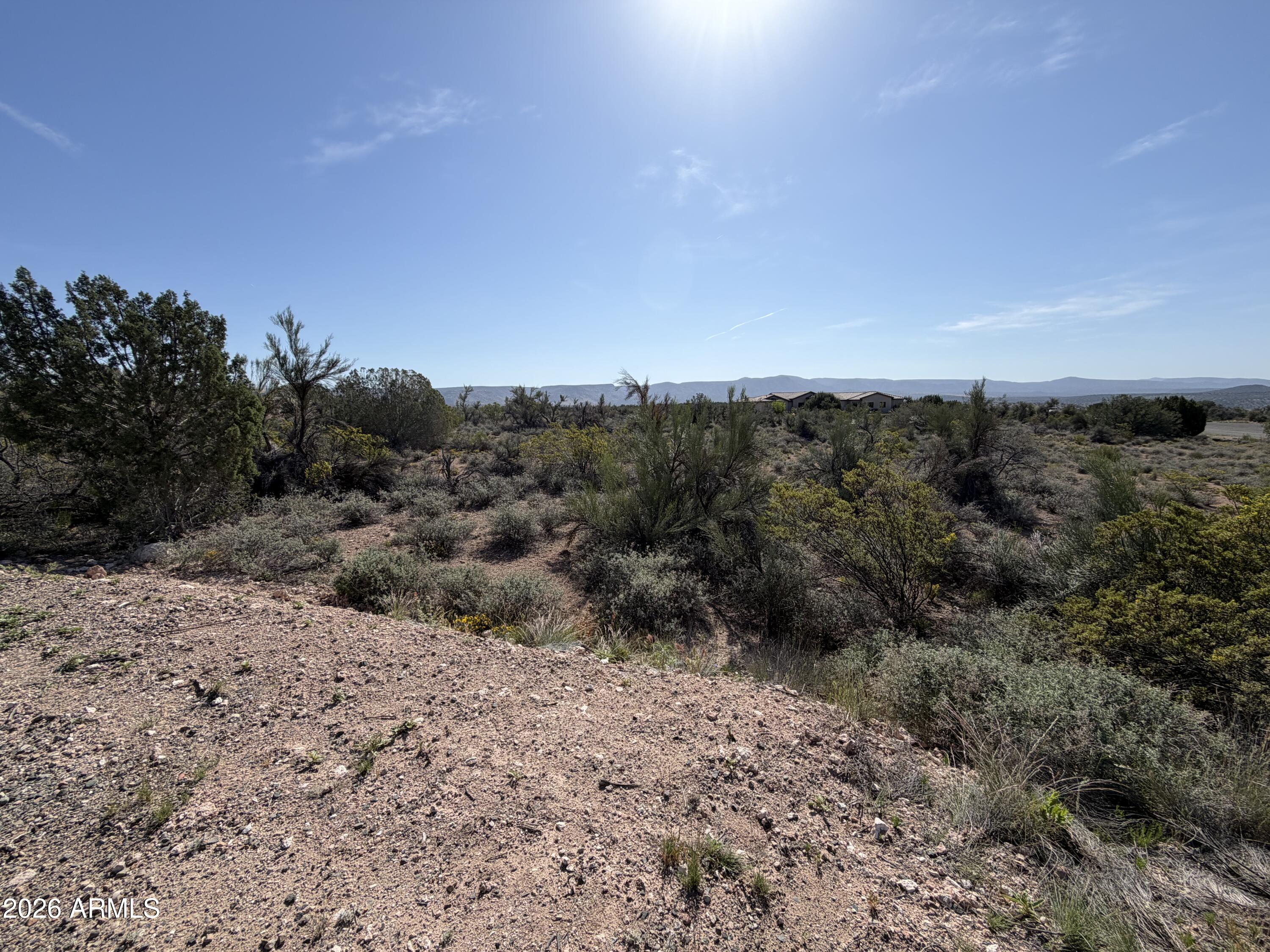 4850 Crazy Horse Circle, Unit 76 Rimrock, AZ 86335 - Photo 2 of 8 a view of a dry yard with trees