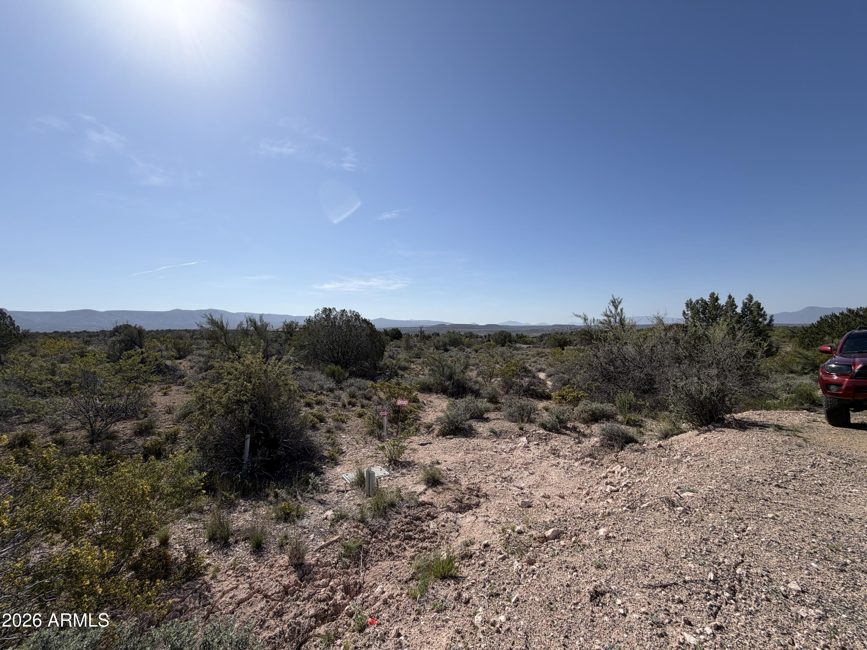 4850 Crazy Horse Circle, Unit 76 Rimrock, AZ 86335 - Photo 7 of 8 a view of a dry yard with mountains in the background