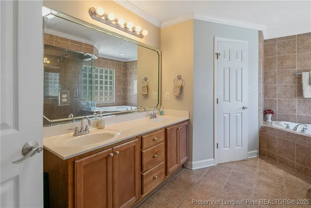 a spacious bathroom with a double vanity sink a large mirror and a shower