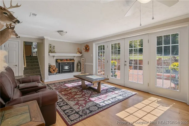a bed sitting in a bedroom next to a window with a chandelier