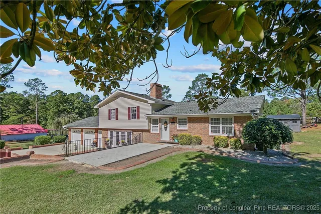 a front view of a house with a garden and plants