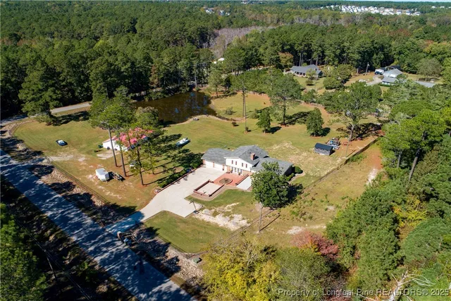 an aerial view of a house with a swimming pool