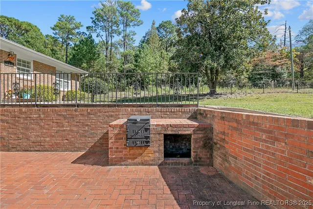 a view of swimming pool with a patio and a yard