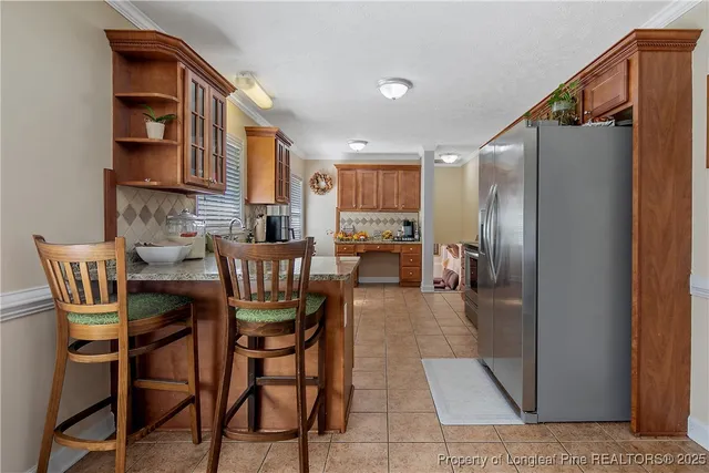a dining room with furniture and a kitchen view