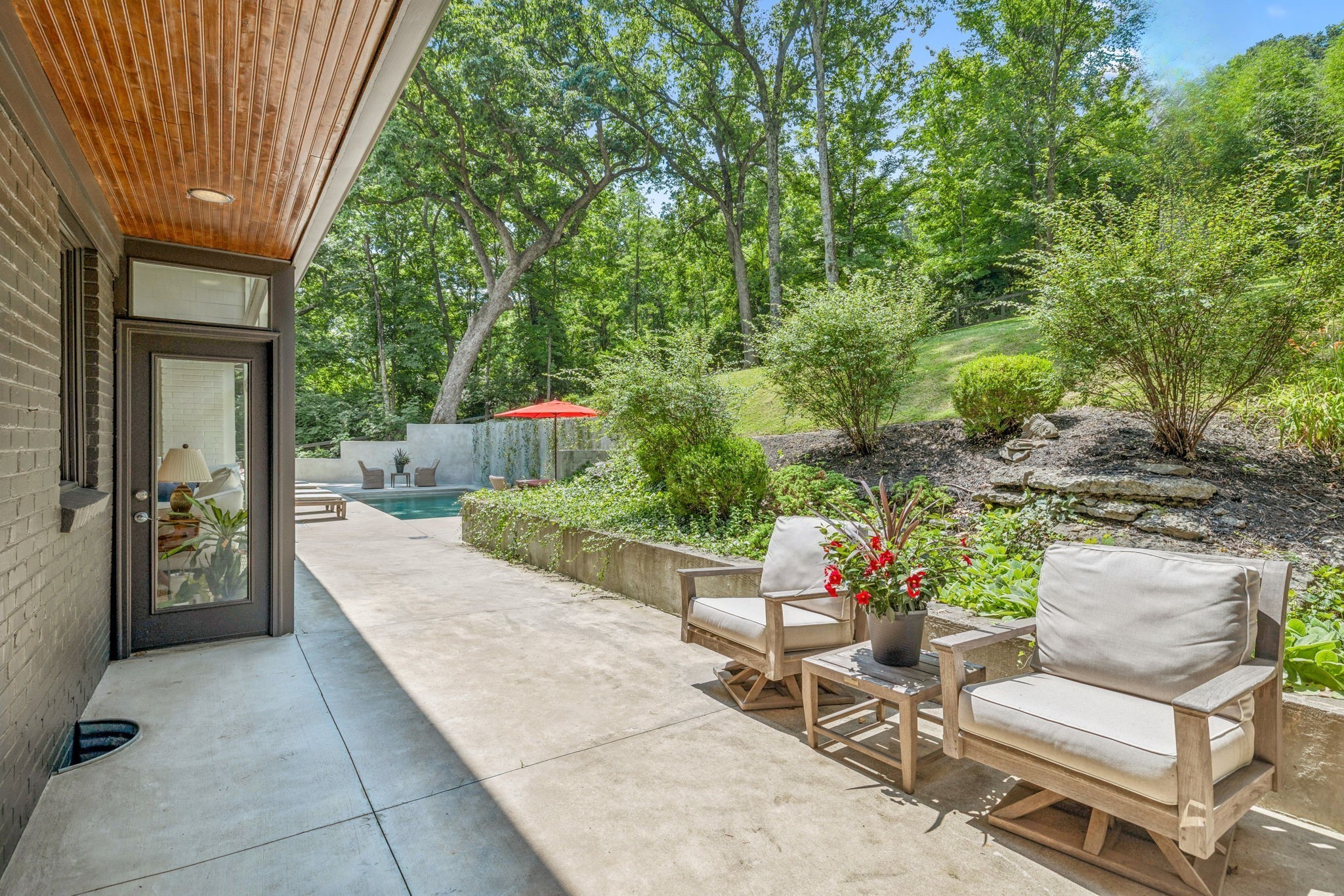 915 Overton Lea Road Nashville, TN 37220 - Photo 67 of 75 a view of a patio with table and chairs potted plants and large tree