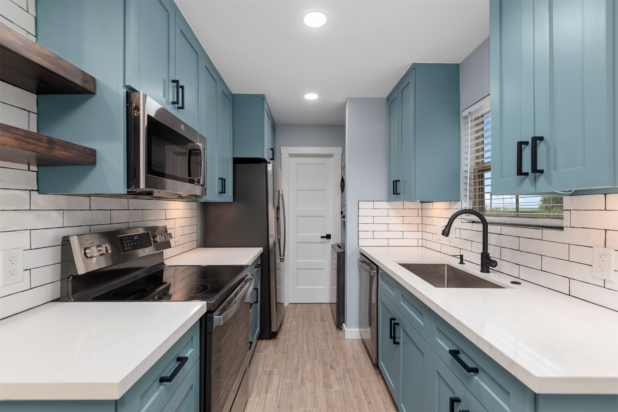 5000 Milwee Street, Unit 54 Houston, TX 77092 - Photo 5 of 25 Every detail considered — custom cabinetry, quartz countertops, and a beautifully functional galley kitchen.