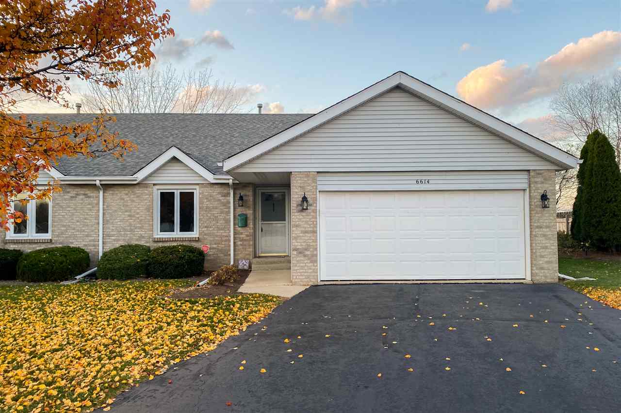 6614 North Point Road Rockford, IL 61108 - Photo 1 of 26 a front view of a house with a yard and garage