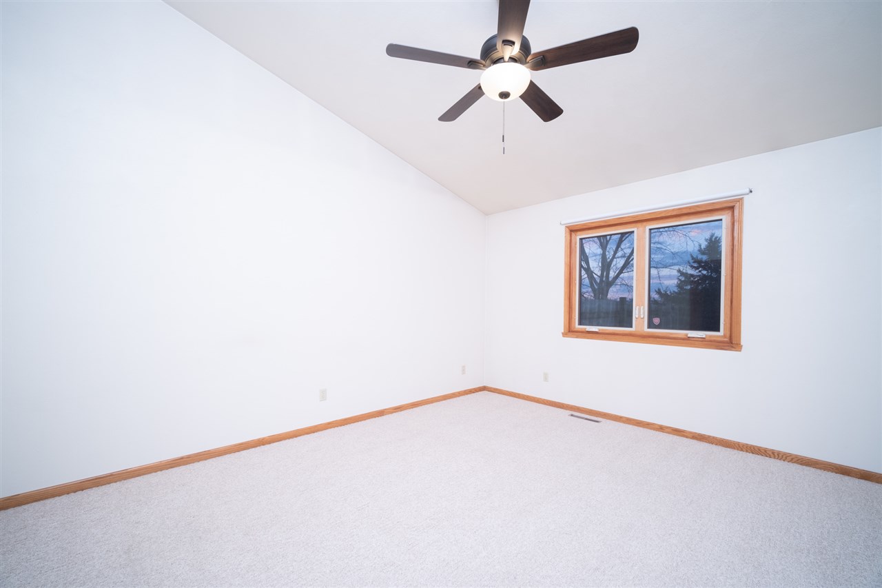 6614 North Point Road Rockford, IL 61108 - Photo 11 of 26 an empty room with a window and a fan