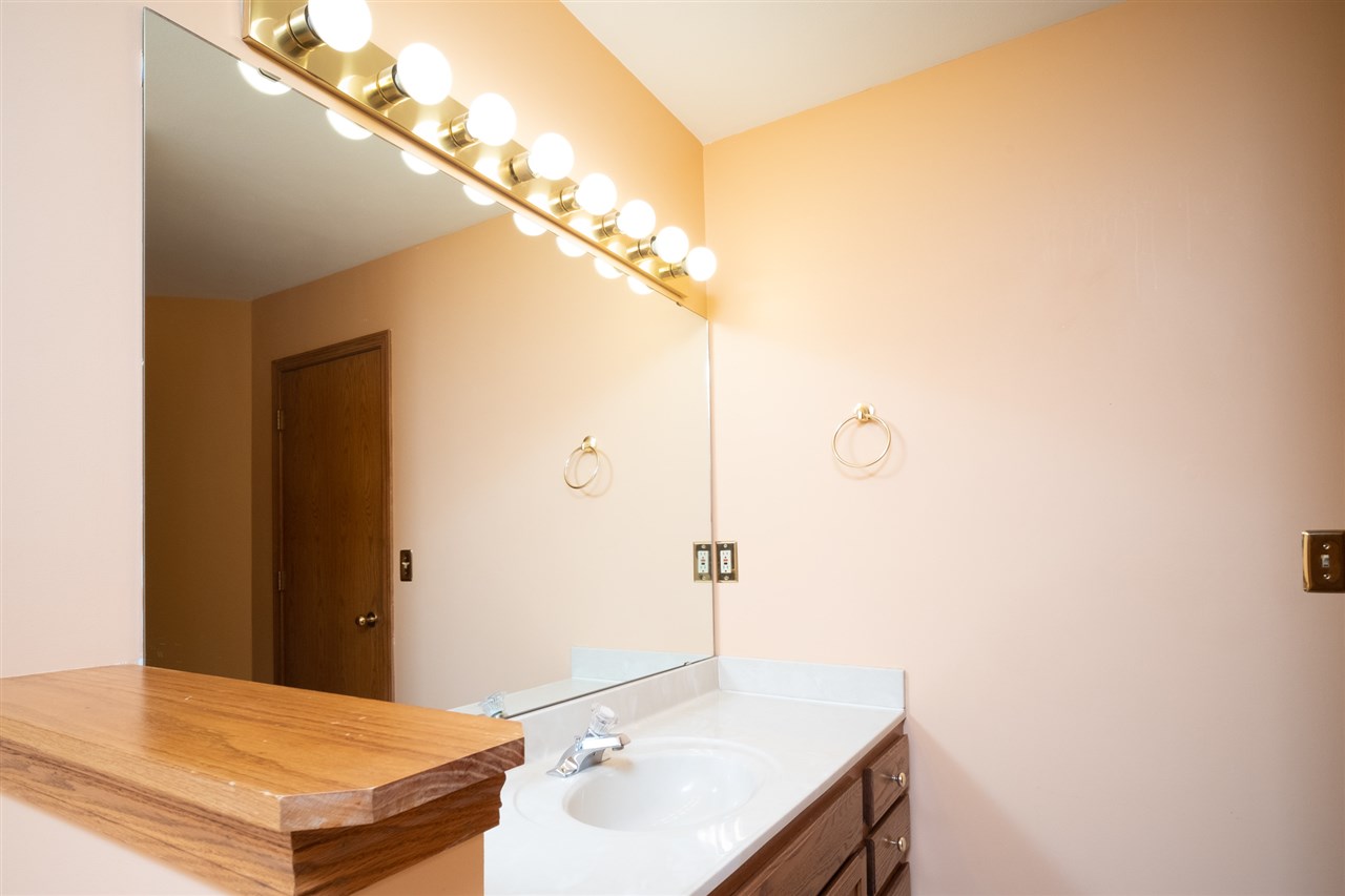 6614 North Point Road Rockford, IL 61108 - Photo 14 of 26 a bathroom with a sink and a mirror