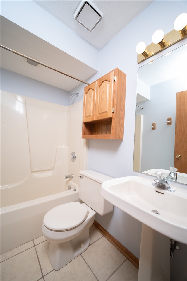 6614 North Point Road Rockford, IL 61108 - Photo 19 of 26 a bathroom with a sink a toilet and shower