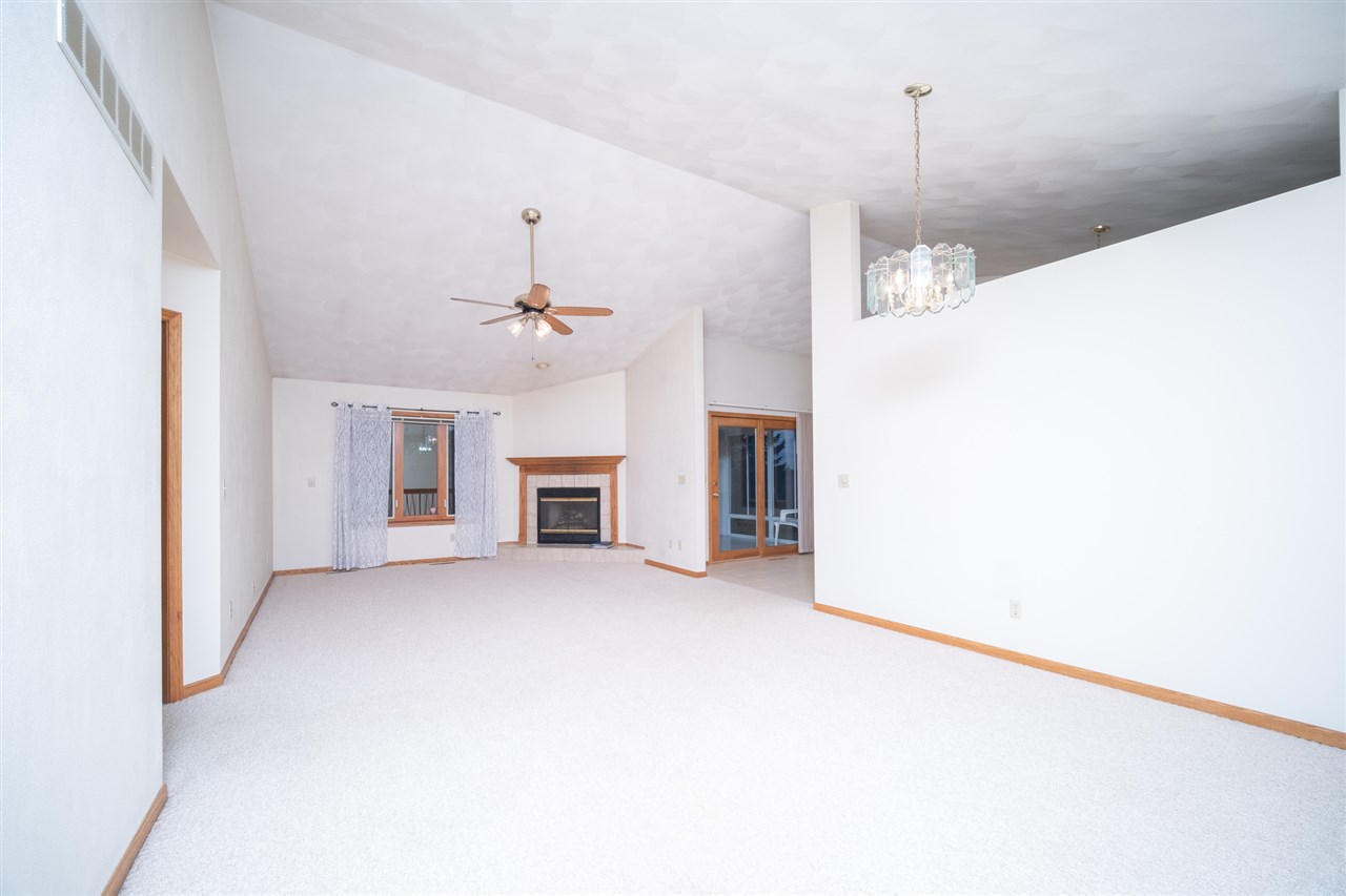 6614 North Point Road Rockford, IL 61108 - Photo 3 of 26 a view of a livingroom with a ceiling fan a kitchen and a chandelier