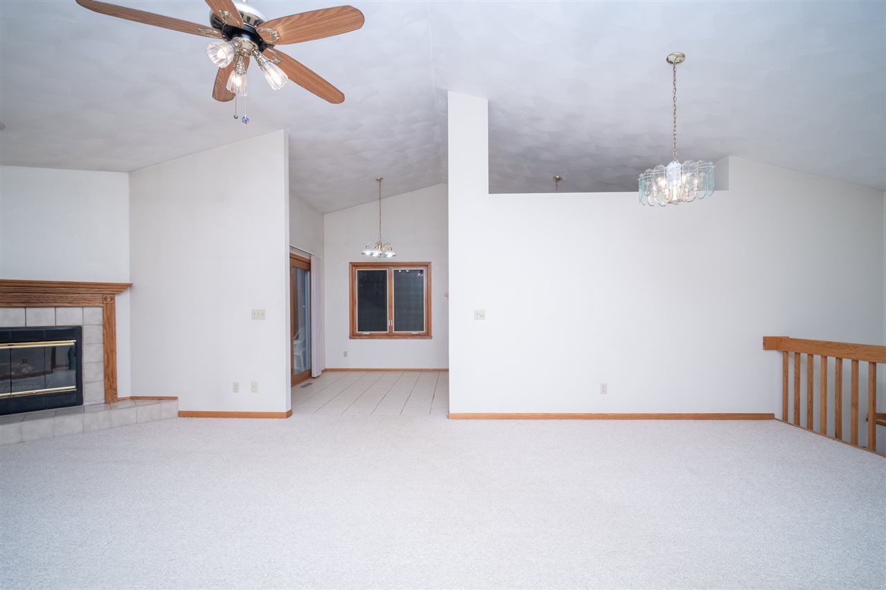 6614 North Point Road Rockford, IL 61108 - Photo 5 of 26 a view of a room with wooden floor and ceiling fan