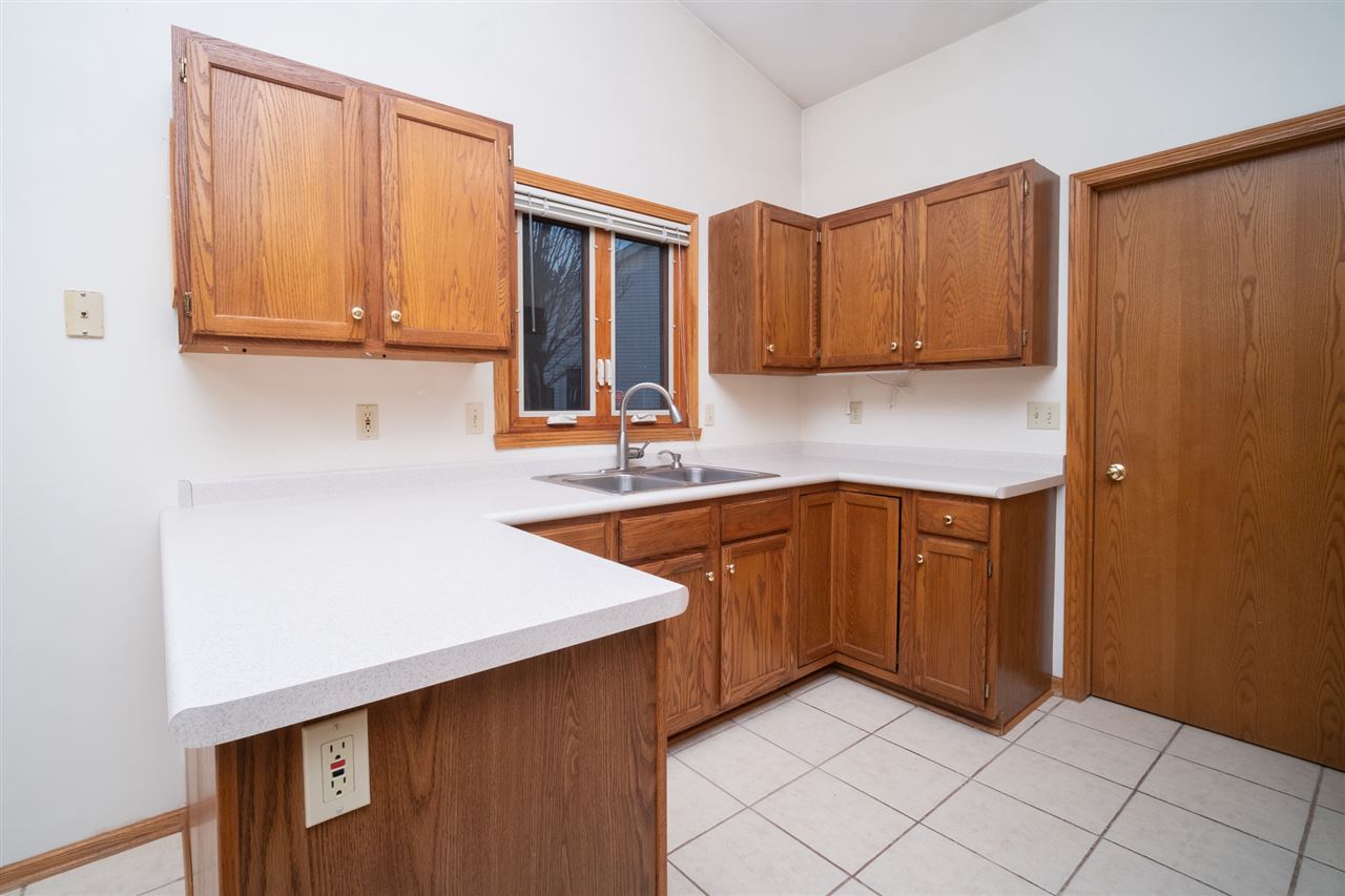 6614 North Point Road Rockford, IL 61108 - Photo 8 of 26 a kitchen with stainless steel appliances granite countertop a sink dishwasher stove and cabinets