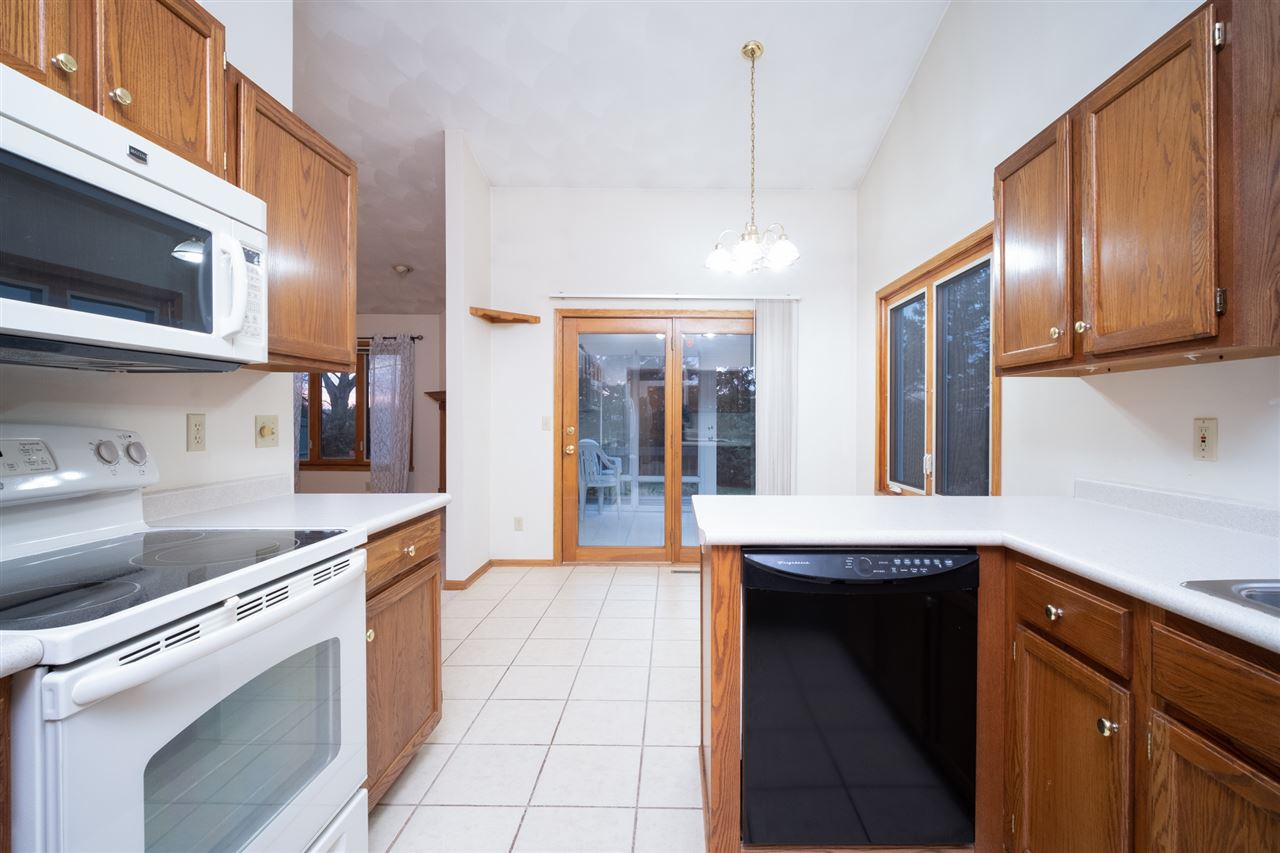 6614 North Point Road Rockford, IL 61108 - Photo 9 of 26 a kitchen with stainless steel appliances granite countertop a stove a sink and a microwave