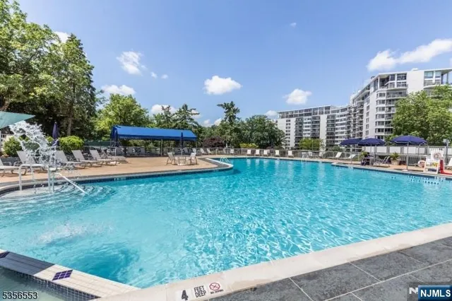 a view of a swimming pool with a yard
