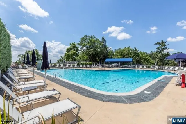 a view of a swimming pool with outdoor seating