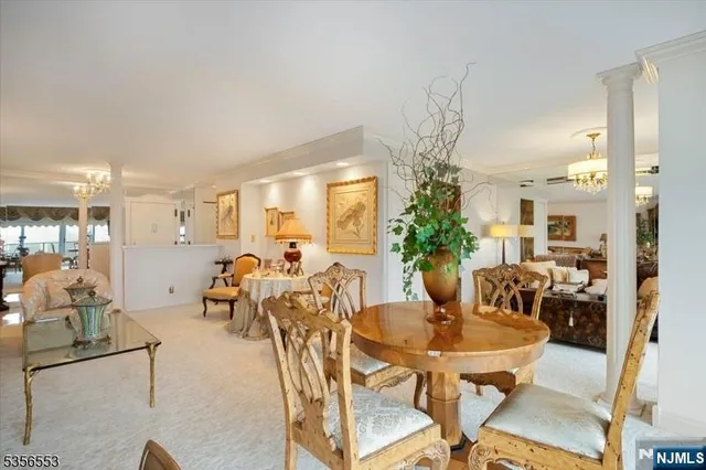 a view of a dining room with furniture and a potted plant