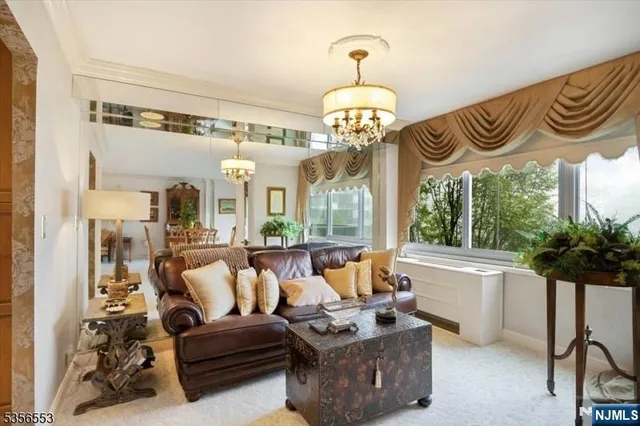 a living room with furniture and a chandelier