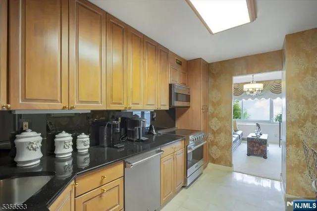 a kitchen with granite countertop sink and cabinets