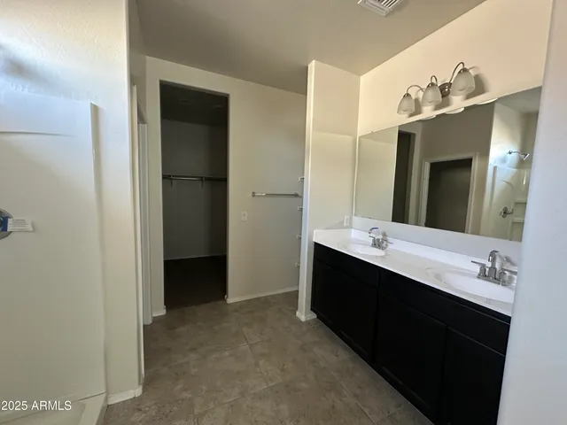 a bathroom with a double vanity sink mirror and