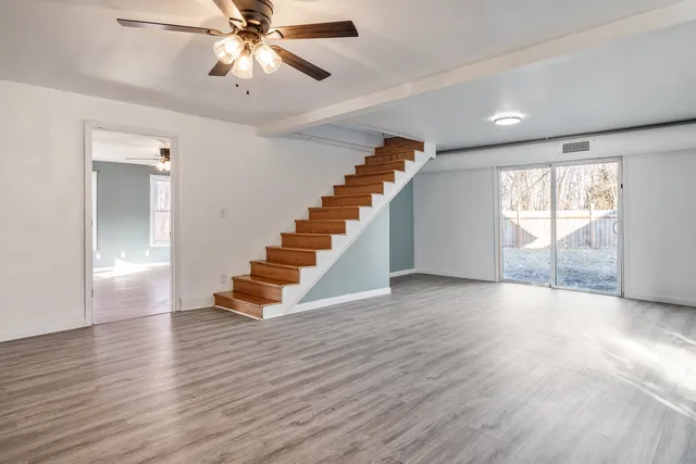 wooden floor in an empty room with a window
