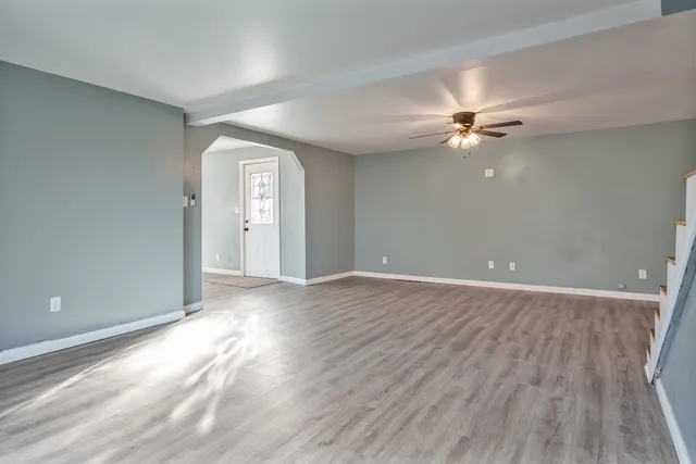 wooden floor in an empty room with a window