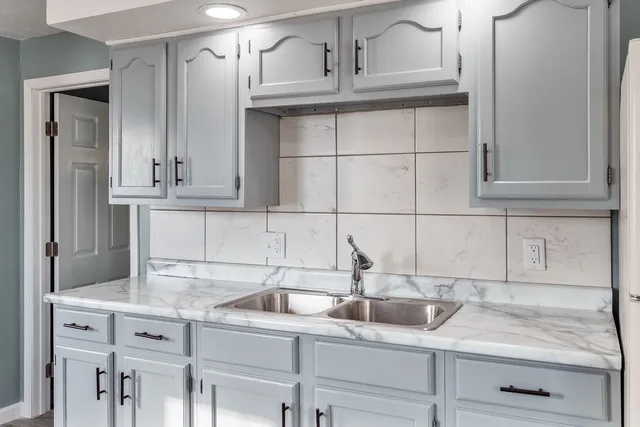 a kitchen with a sink and cabinets
