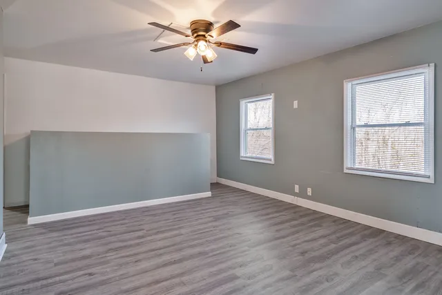 wooden floor in an empty room with a window