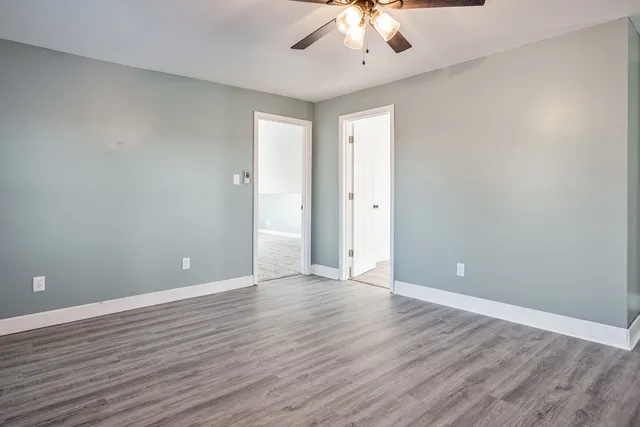 a view of an empty room with wooden floor
