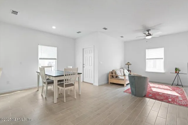 a dining room with furniture and window