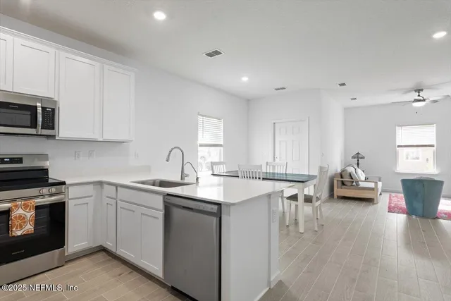 a kitchen with sink cabinets and wooden floor