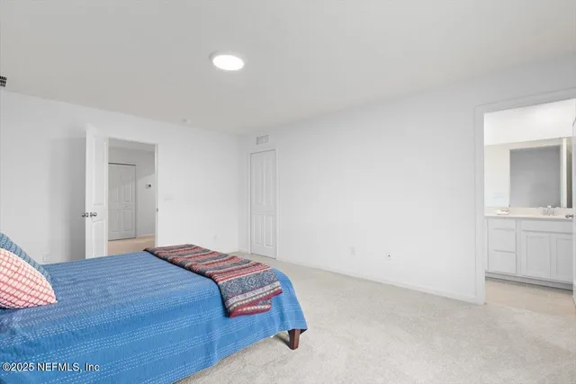 a bedroom with a bed and cabinets