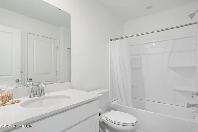 a bathroom with a granite countertop sink toilet a mirror and shower