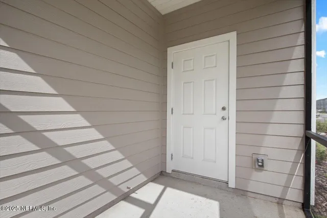 a balcony with table and chairs