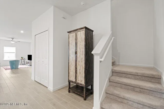 a view of entryway with wooden floor and livingroom view