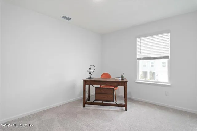 a living room with a chair and a window