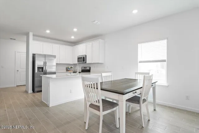 a kitchen with a table and chairs in it