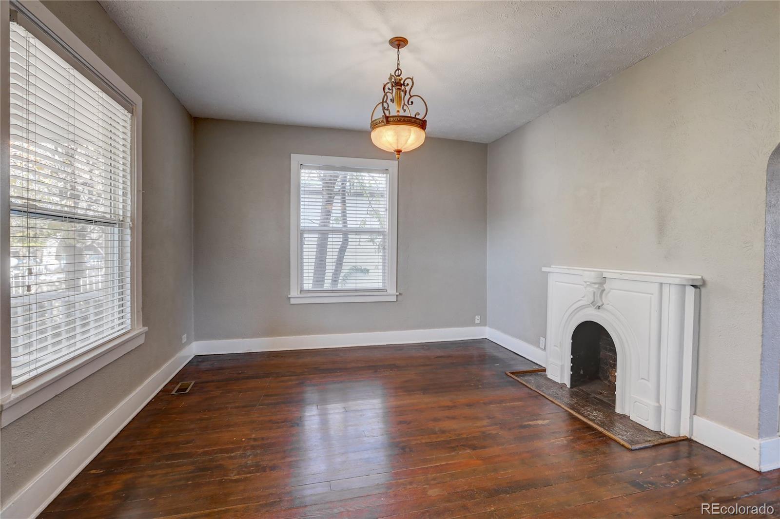 418 Inca Street Denver, CO 80204 - Photo 3 of 24 a view of empty room with wooden floor and window