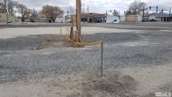 a view of a tall building next to a yard