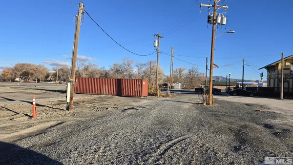 a view of a street with a car parked in front of it
