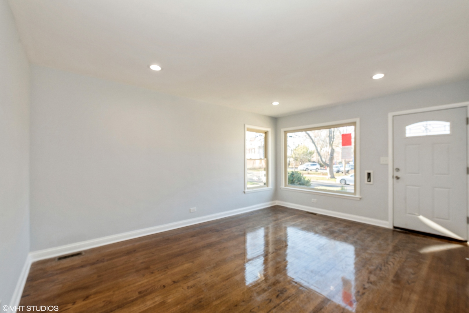 1023 Rice Avenue Bellwood, IL 60104 - Photo 3 of 12 an empty room with wooden floor and windows